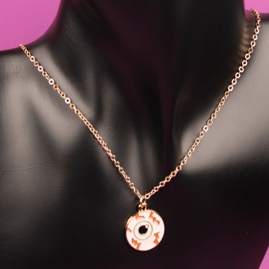 Necklace with a pendant on a black mannequin bust against a pink background