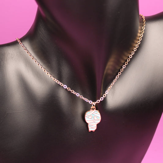 Necklace with a pendant on a black mannequin bust against a pink background