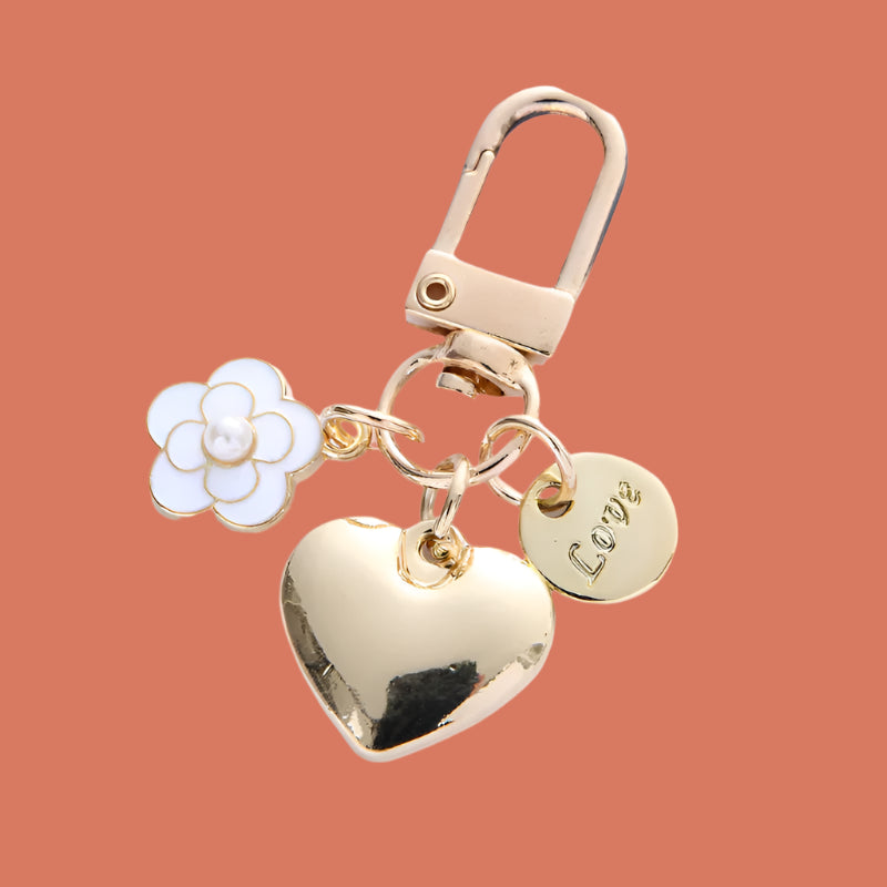 Gold keychain with heart, flower, and 'LOVE' tag charm