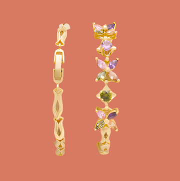 Gold earrings with multicolored gemstones.