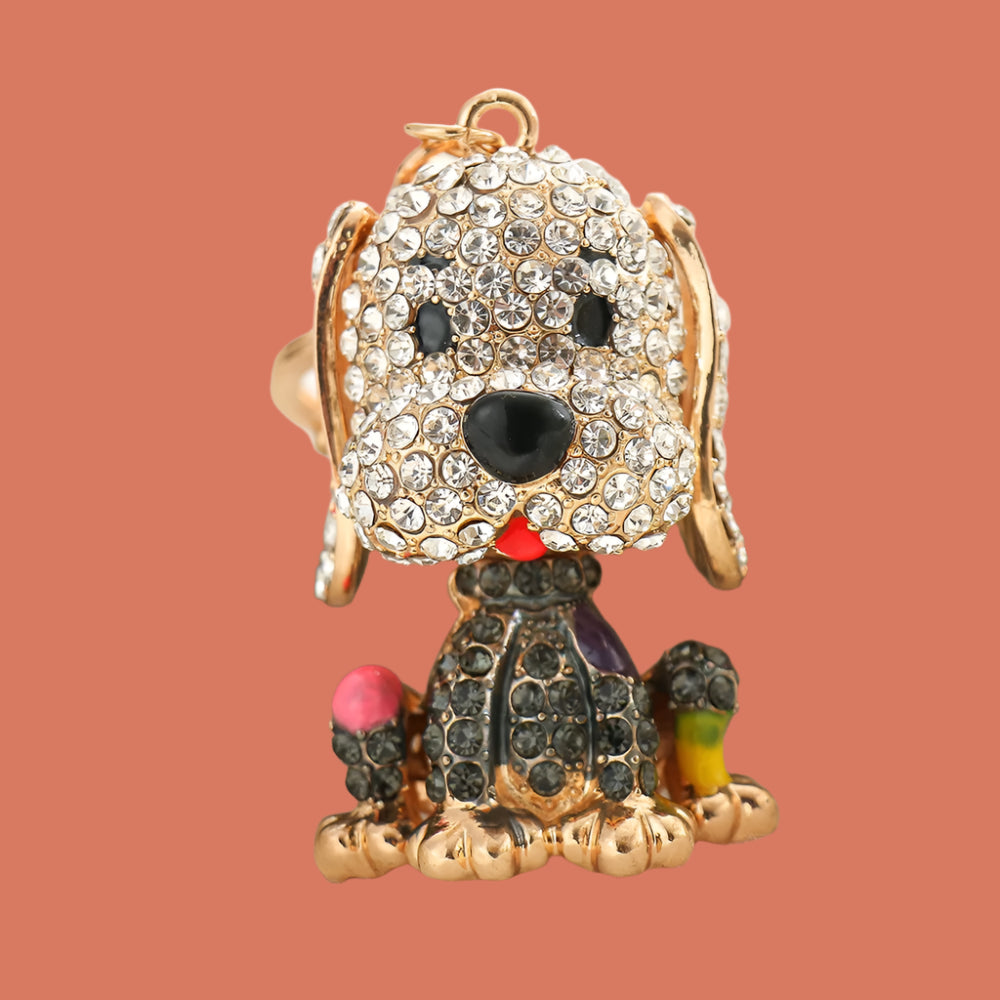 Decorative dog bag charm with rhinestones on a white surface