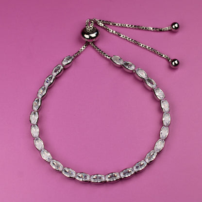 Silver beaded bracelet on a pink background