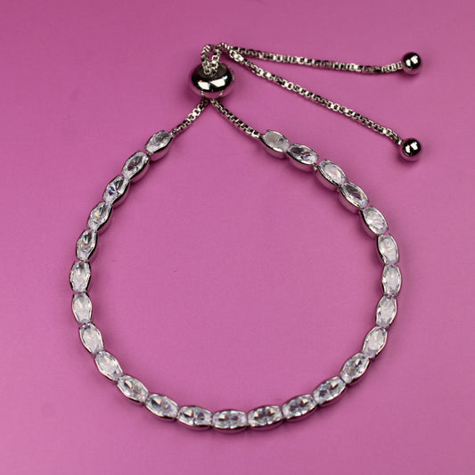 Silver beaded bracelet on a pink background