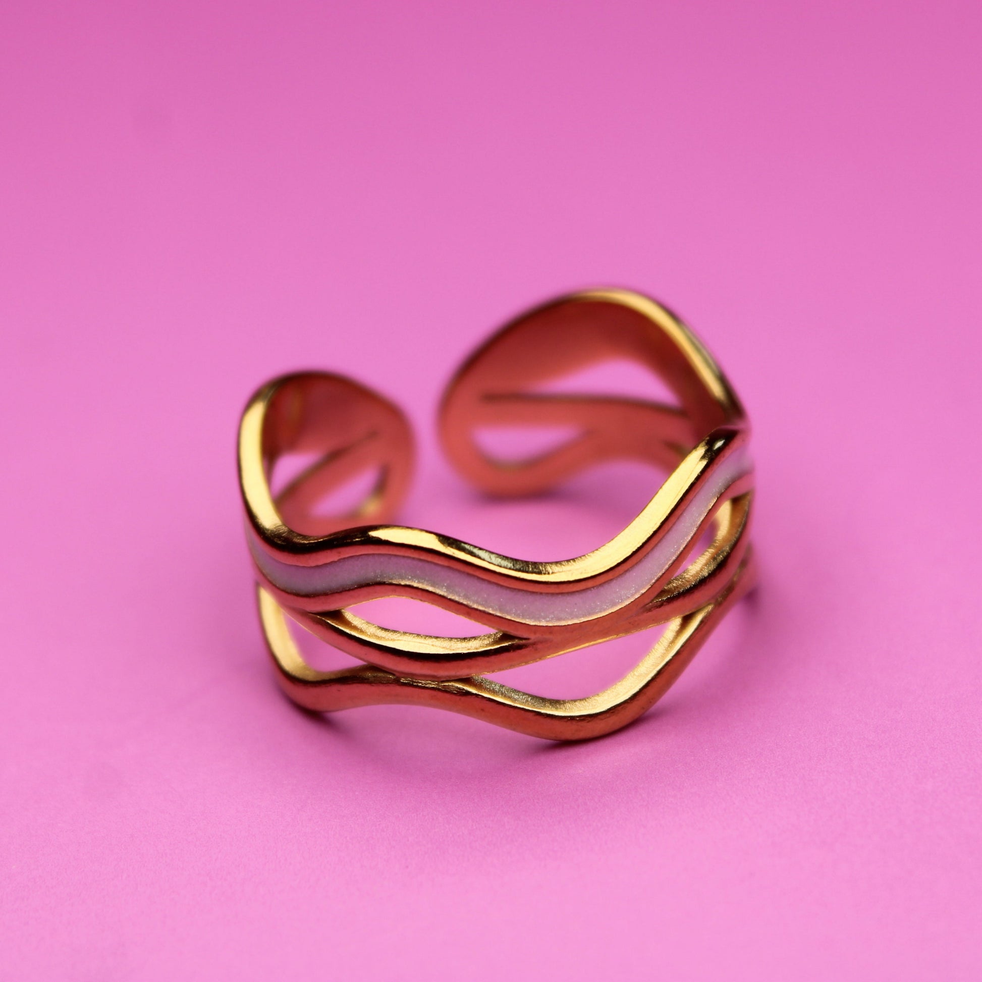 Gold ring on a pink background