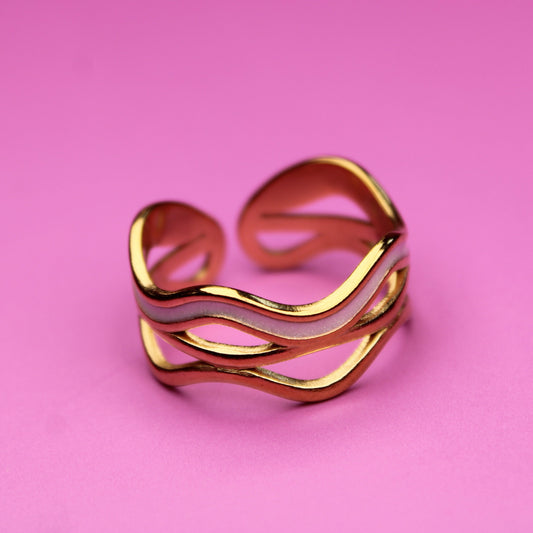 Gold ring on a pink background