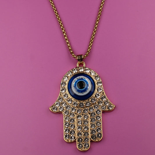 Hamsa hand necklace with blue eye on a pink background