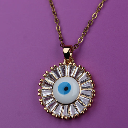 Necklace with a round pendant featuring an eye design on a purple background