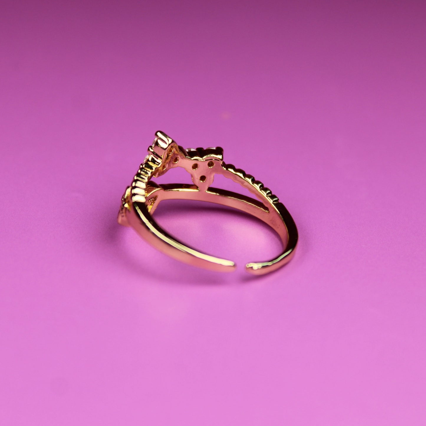 Gold ring on a pink background