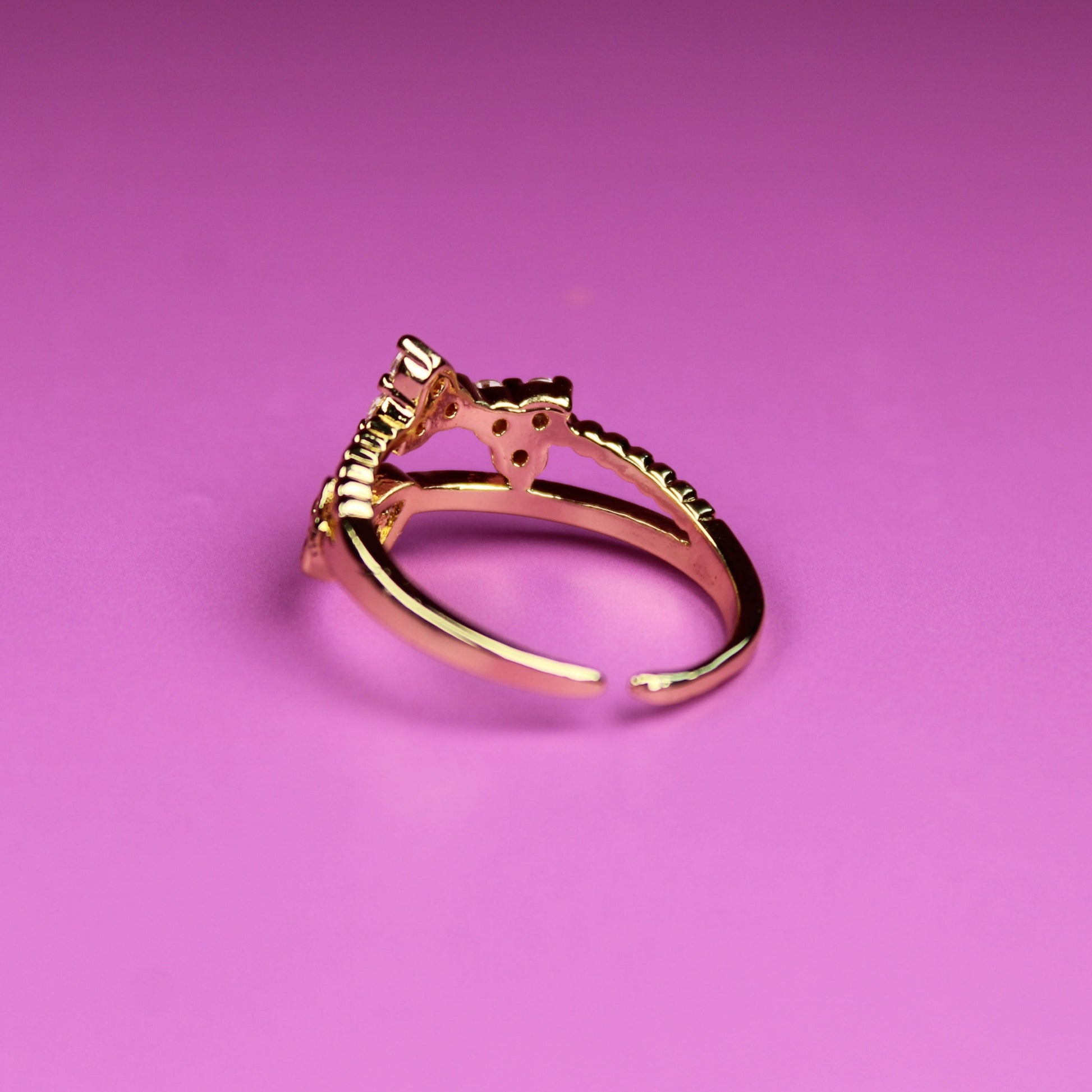 Gold ring on a pink background