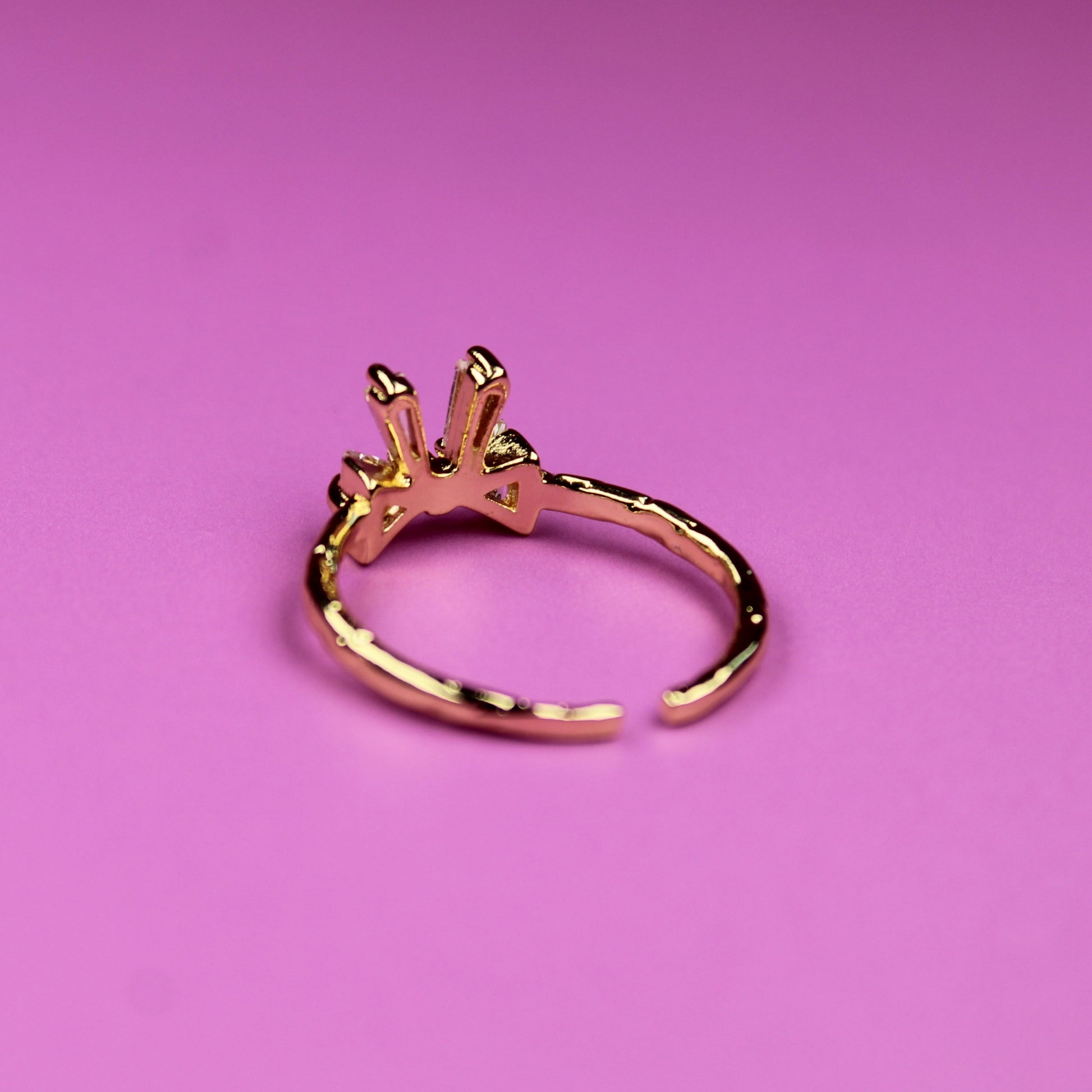 Gold ring on a pink background