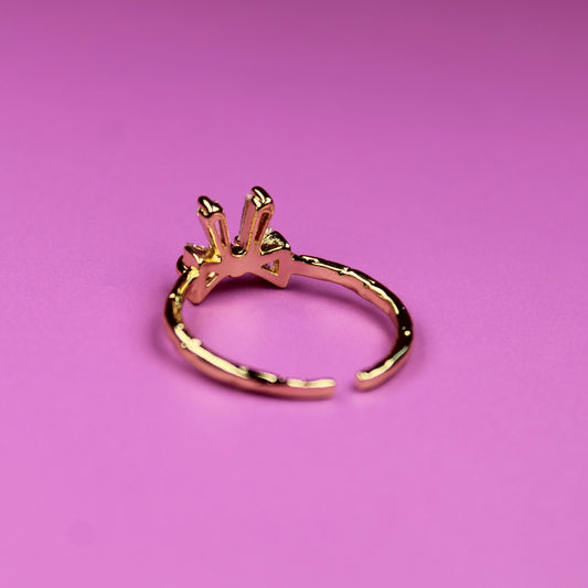 Gold ring on a pink background