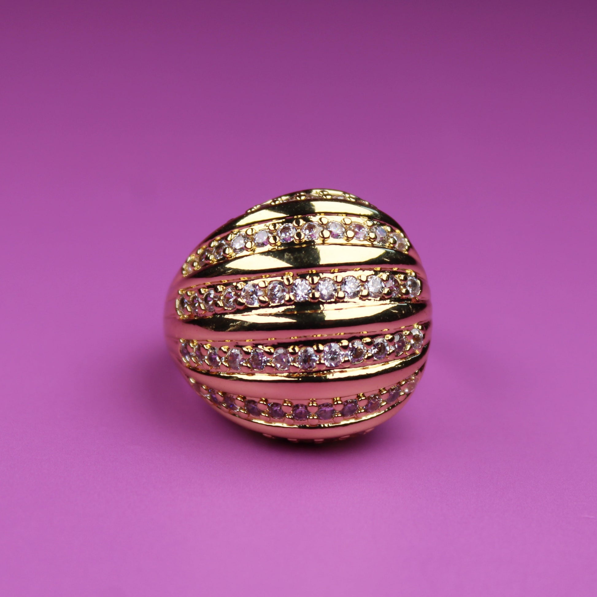 Gold and pink decorative ball on a pink background