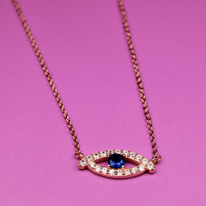 Necklace with eye-shaped pendant on a pink background