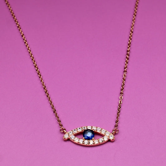 Necklace with eye-shaped pendant on a pink background