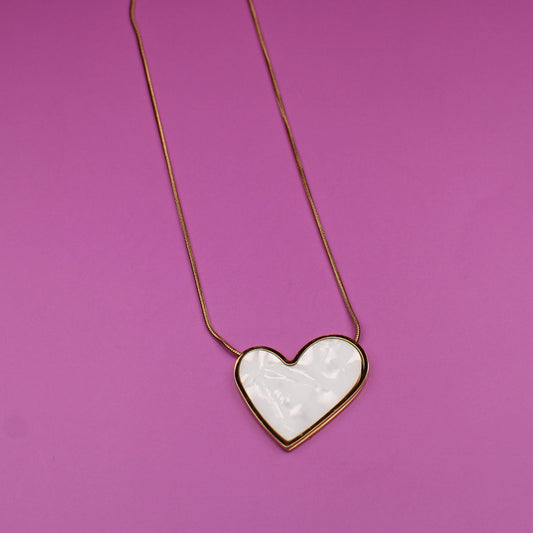 Heart-shaped pendant on a pink background