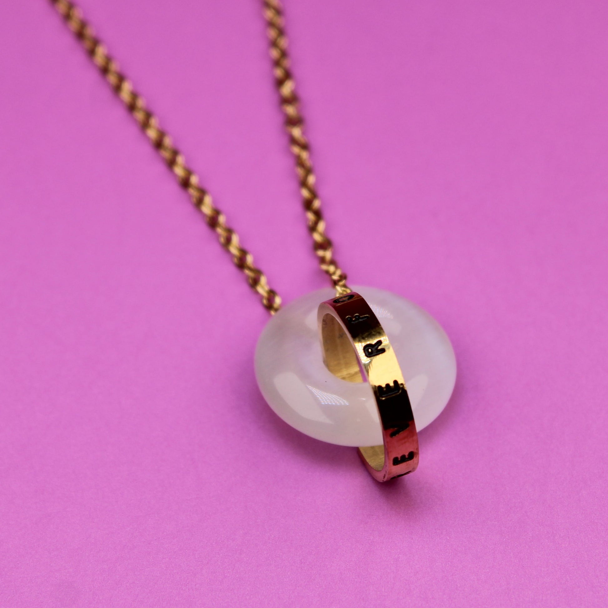 Necklace with a pendant on a pink background