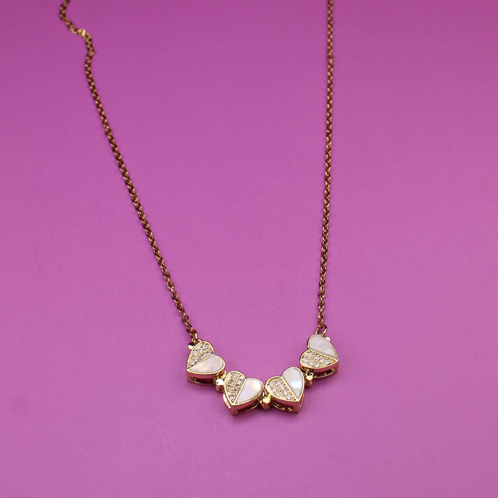 Necklace with heart-shaped pendants on a purple background