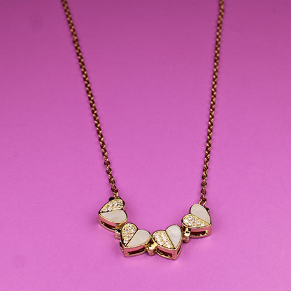 Necklace with heart-shaped pendants on a pink background