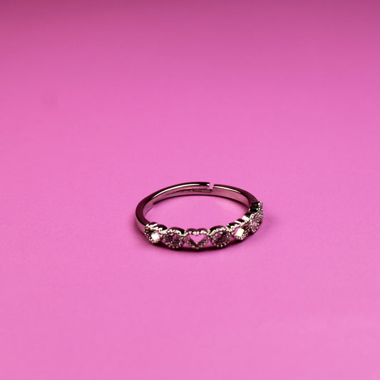 Small ring with pink stones on a pink background
