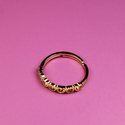 Gold ring on a pink background