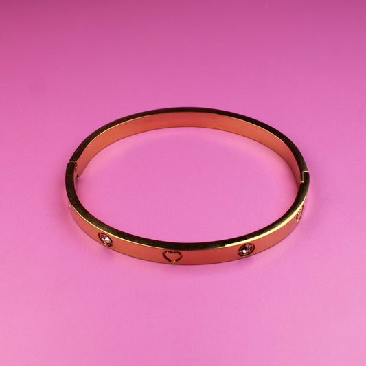 Rose gold bracelet on a pink background
