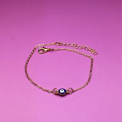 Gold bracelet with a purple gemstone on a pink background