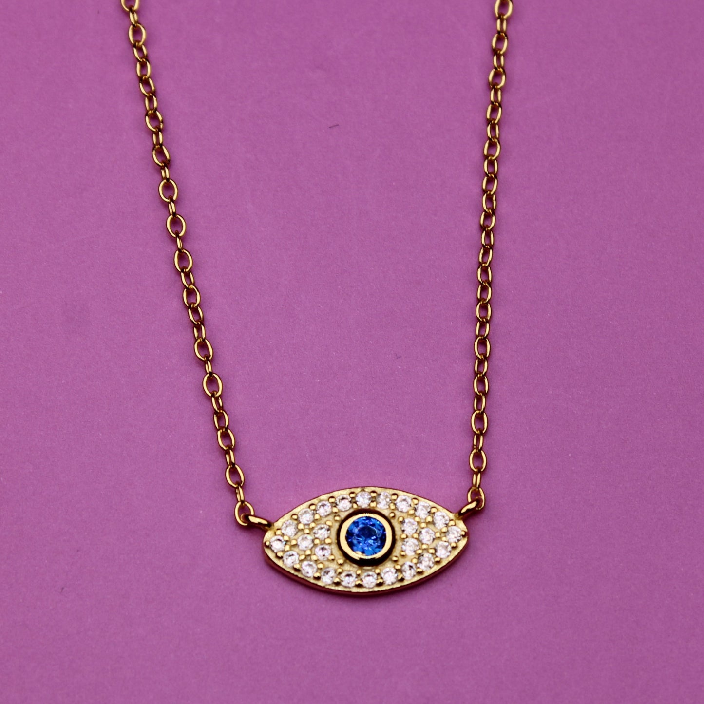 Necklace with an eye-shaped pendant on a purple background
