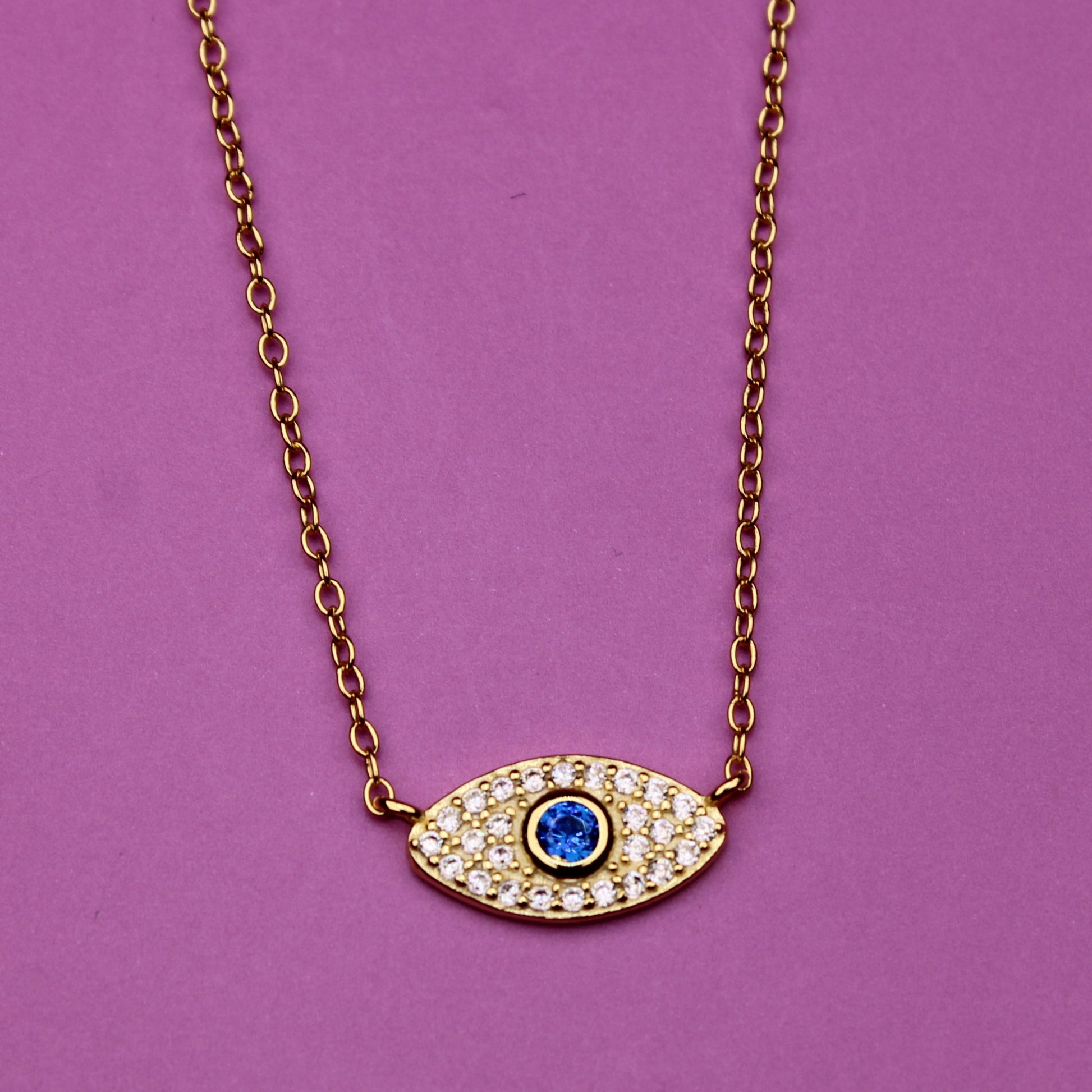 Necklace with an eye-shaped pendant on a purple background