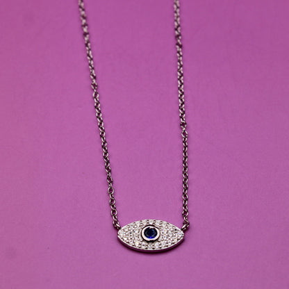 Necklace with an eye-shaped pendant on a pink background