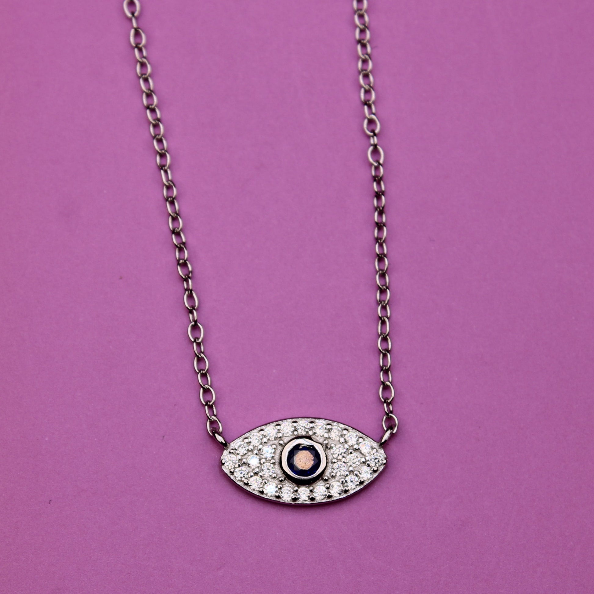 Necklace with an eye-shaped pendant on a purple background