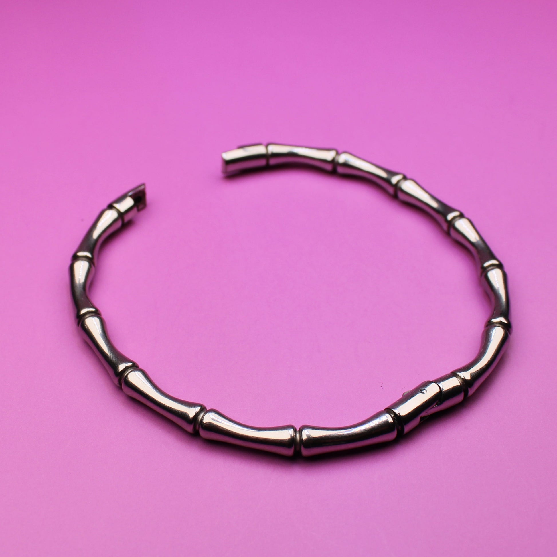 Silver bracelet on a pink background