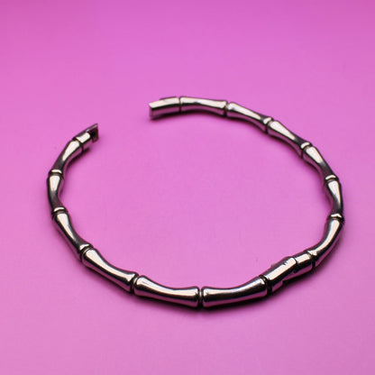 Silver bracelet on a pink background