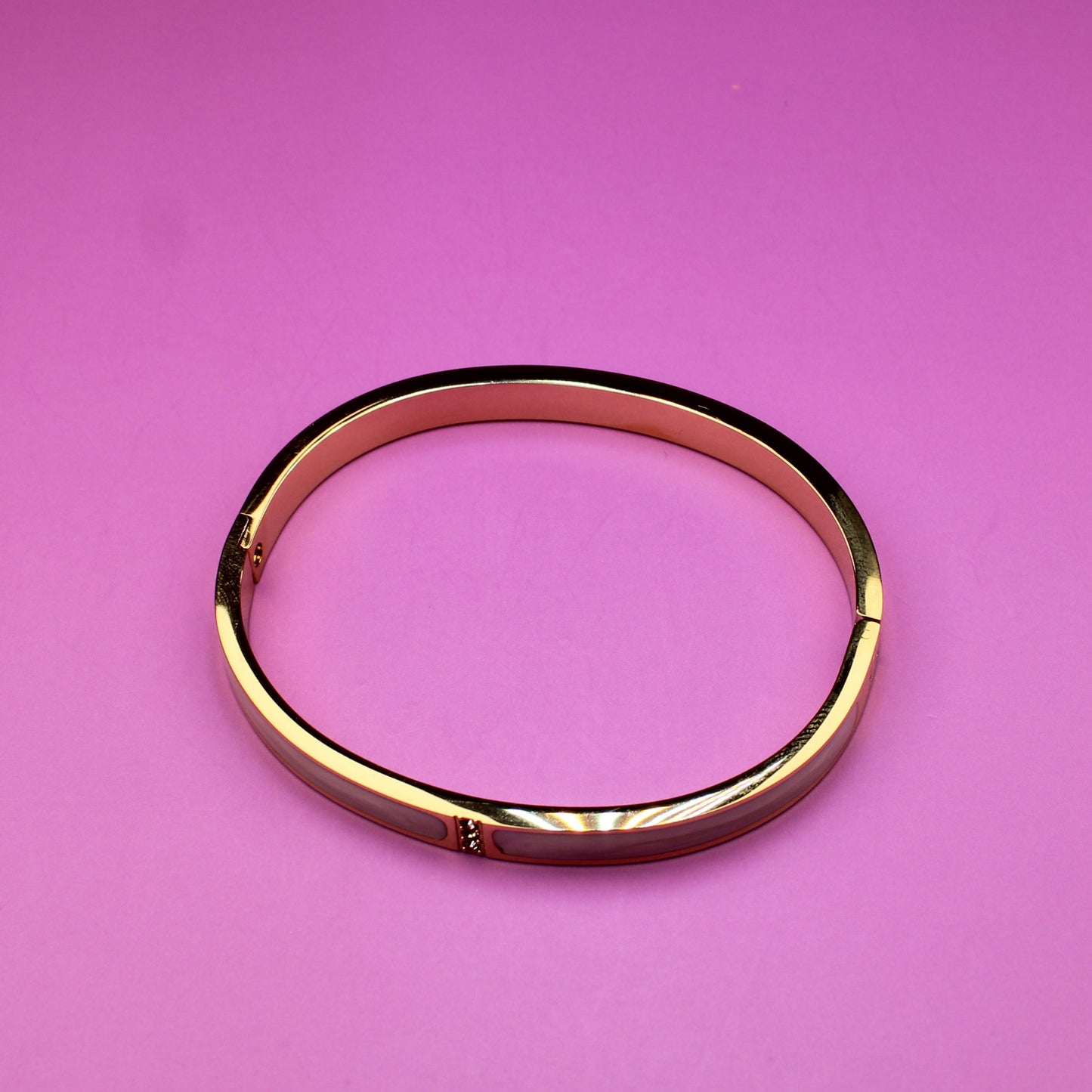 Gold ring on a pink background