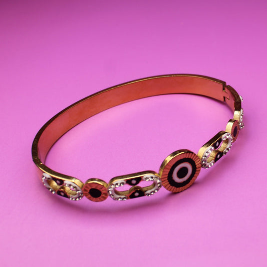 Decorative bracelet with circular patterns on a pink background