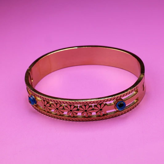 Decorative ring with blue stones on a pink background
