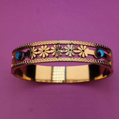 Decorative ring with floral patterns and gemstones on a purple background