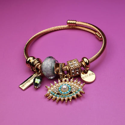 Gold bracelet with charms on a purple background