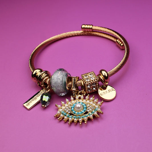 Gold bracelet with charms on a purple background