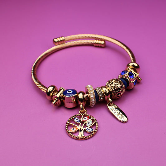 Bracelet with charms on a pink background