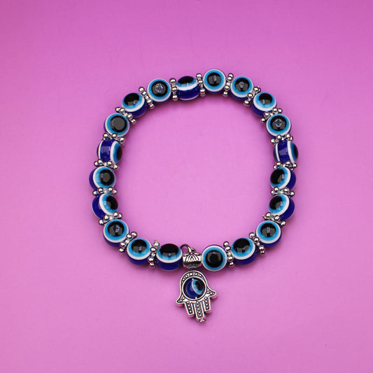 Bracelet with blue beads on a pink background