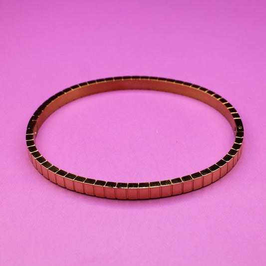 Metallic belt on a pink background