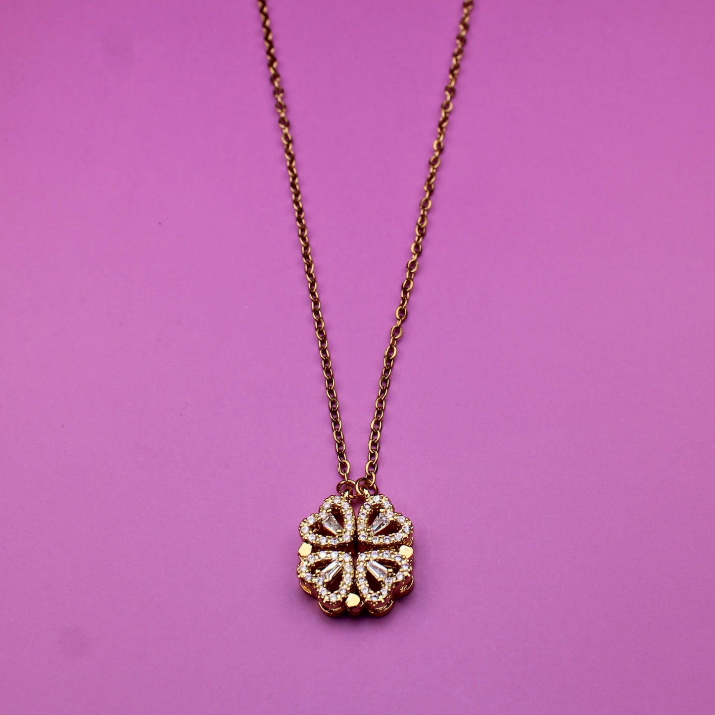Necklace with a floral pendant on a pink background