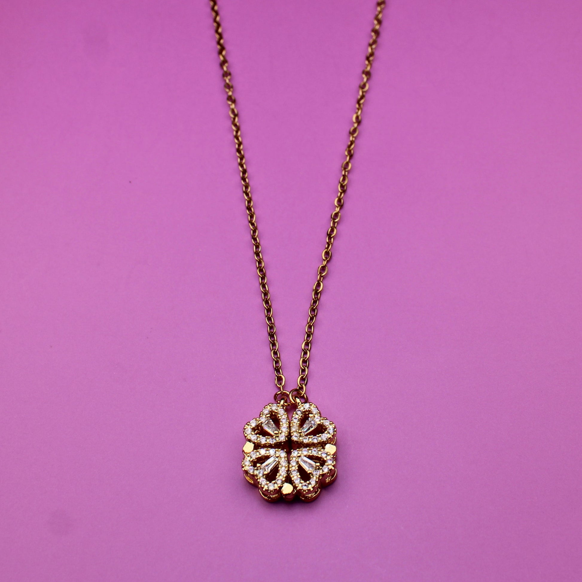 Necklace with a floral pendant on a pink background