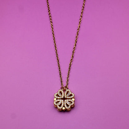 Necklace with a floral pendant on a pink background