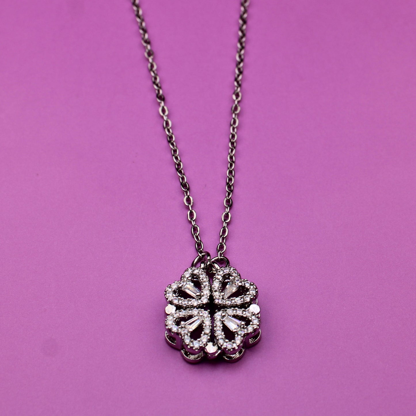 Necklace with a floral pendant on a pink background