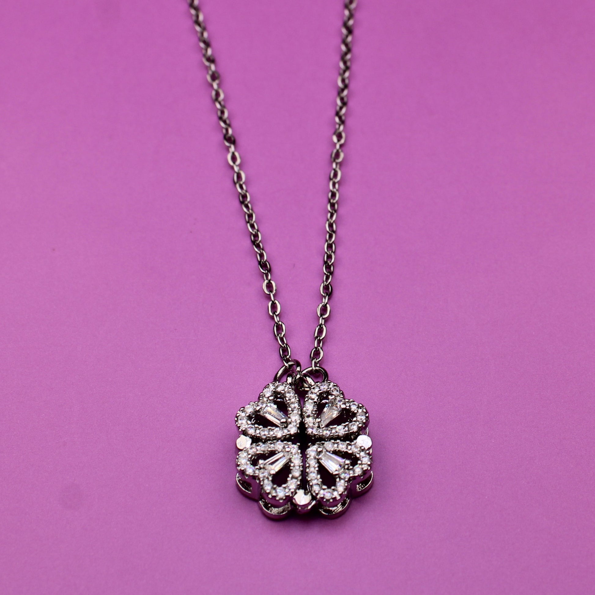 Necklace with a floral pendant on a pink background