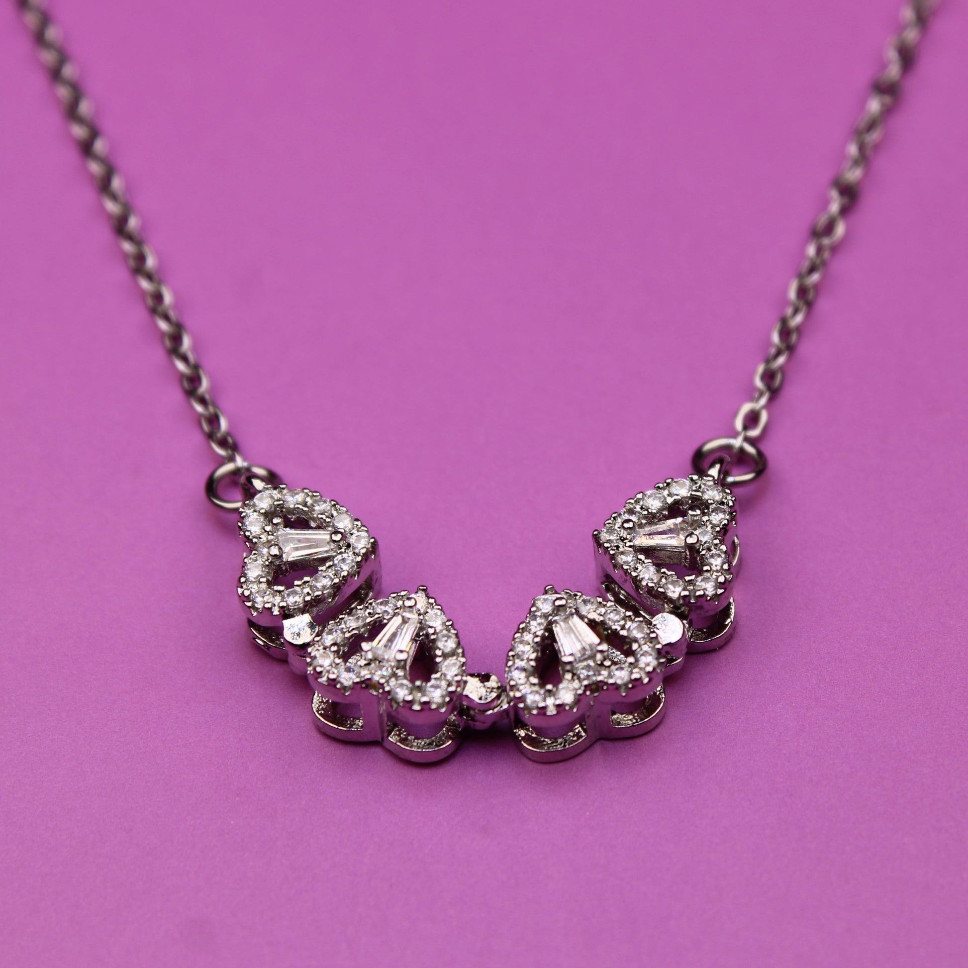 Necklace with diamond-like stones on a pink background