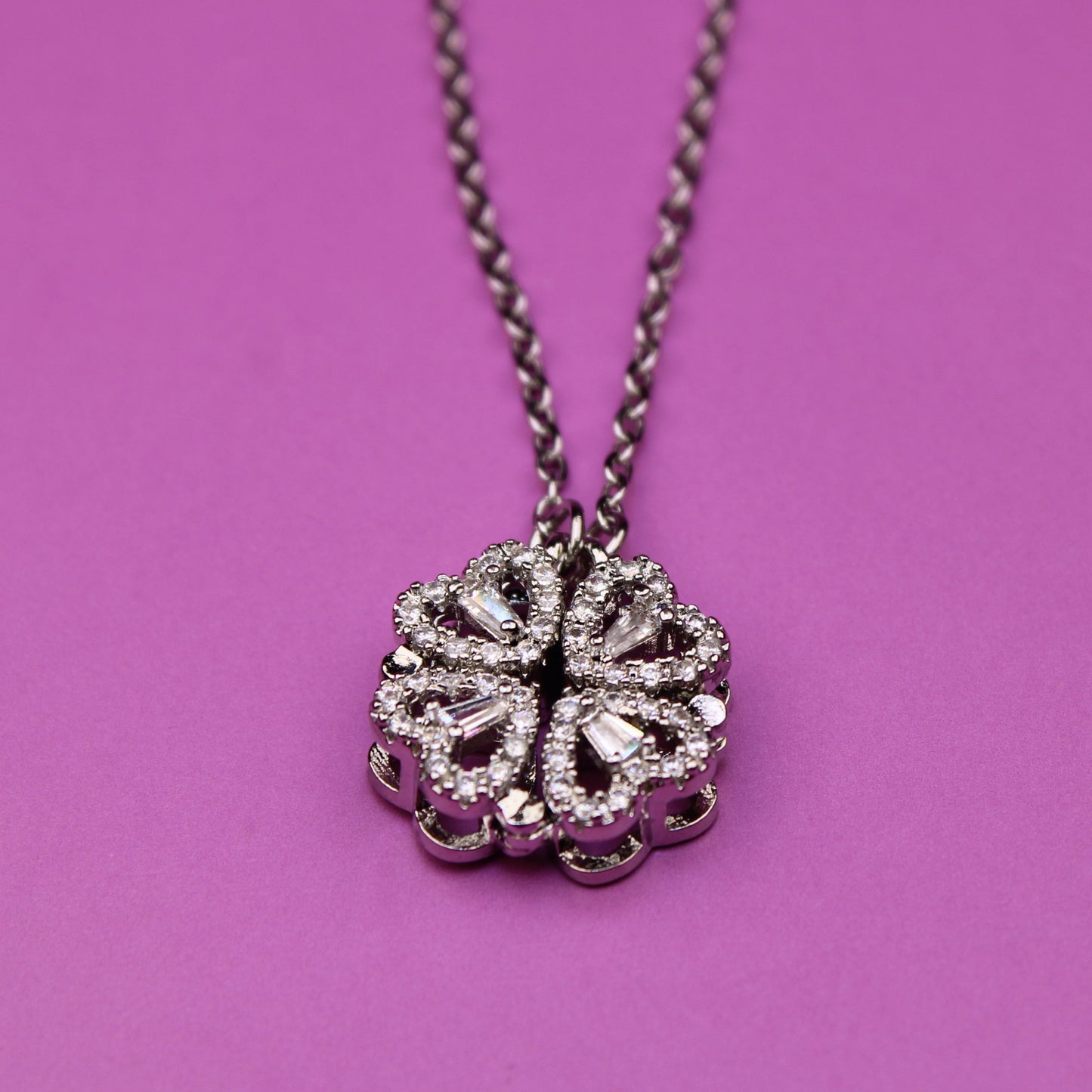 Necklace with a decorative pendant on a pink background