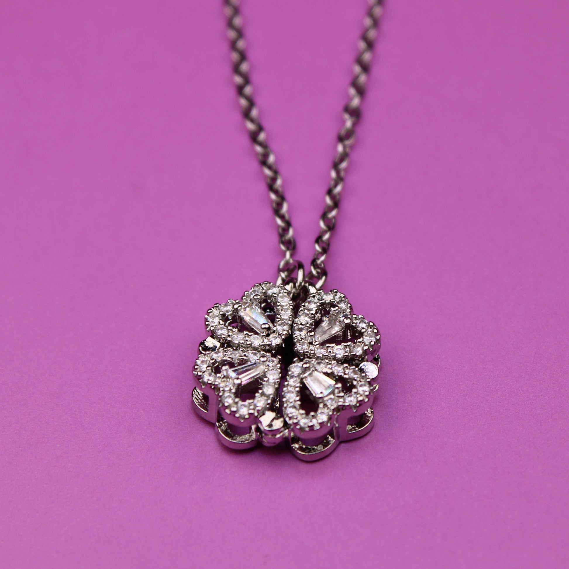 Necklace with a decorative pendant on a pink background