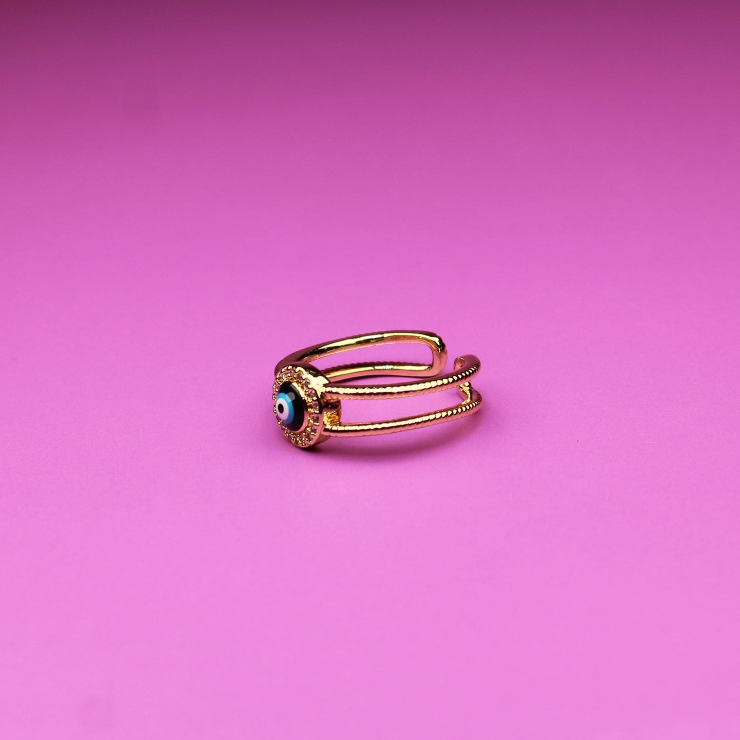 Gold ring on a pink background